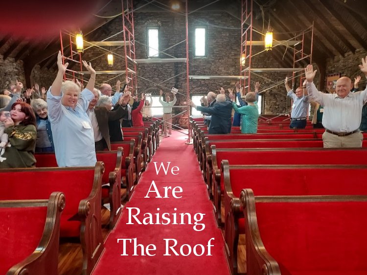 congregation raising hands to show we are beginning our roof project